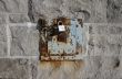 Iron lock and rusty chain on a stone wall