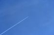 Jet airplane going up in the blue sky