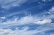 Curly white clouds in the blue sky