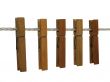 Wooden clothespins on a clothes line (+ clipping path)