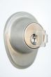 Metallic door lock with a key