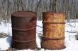 Two rusty iron barrels