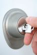 Hand unlocking the door with a key