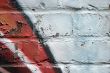 Graffiti on a peeling brick wall