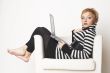 Nice blondgirl sitting on the chair with laptop