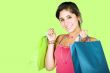 girl with shopping bags over green