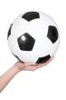 female hand holding a soccer ball