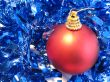 Red christmas ball on blue glare