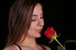 Woman smelling a red rose