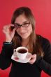 Girl smiling holding tea and glasses