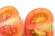 Partial image of cut red tomato in to halves