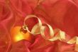 Gold ball and ribbon on a red background