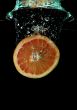 Grapefruit falling into water