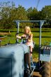 Farmer`s daughter on a tractor