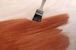 Newly painted wooden surface and brush