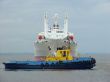 Tugboat towing a ship.