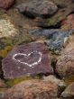 Heart sign drawn on a stone of a river shore.