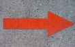 Red Painted Arrow on Concrete