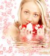 happy blond in water with red and white flowers