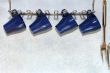 four dark blue cups