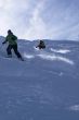 Yellow skiers in powder snow