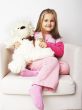 Nice young girl in pink on light background with teddy bear