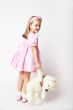 Nice young girl in pink on light background with teddy bear