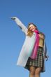 The happy girl on a background of the blue sky