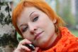 young red-haired woman with umbrella