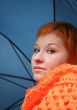 young red-haired woman with umbrella