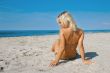 young tanned girl on sandy beach