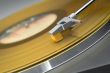 Yellow vinyl record on turntable - tilted view