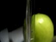Apple on a background of a glass with water