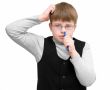 schoolboy picks one`s nose