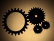 cogwheels over a gold metal texture