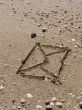 envelope on wet sea sand