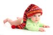 a little baby in a large red hut portrait