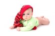 a little baby in a large red hut portrait