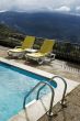 Long chairs by the pool 3