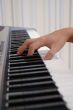 a hand playing piano