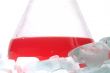 red liquid in Flask behind ice