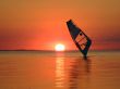 Silhouette of a windsurfer on waves of a gulf