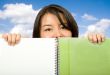 beautiful student looking over notebook