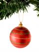 bauble in red hanging from christmas tree