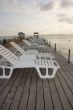 Chaise longues on pier