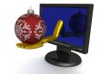 Christmas toy on a hand, put out from the monitor.
