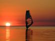 Silhouette of a windsurfer on waves on a sunset 2