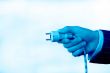 hand with an electric plug