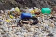 Plastic and rubber garbage on a stony beach