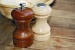 Wooden pepper and salt mill on a table